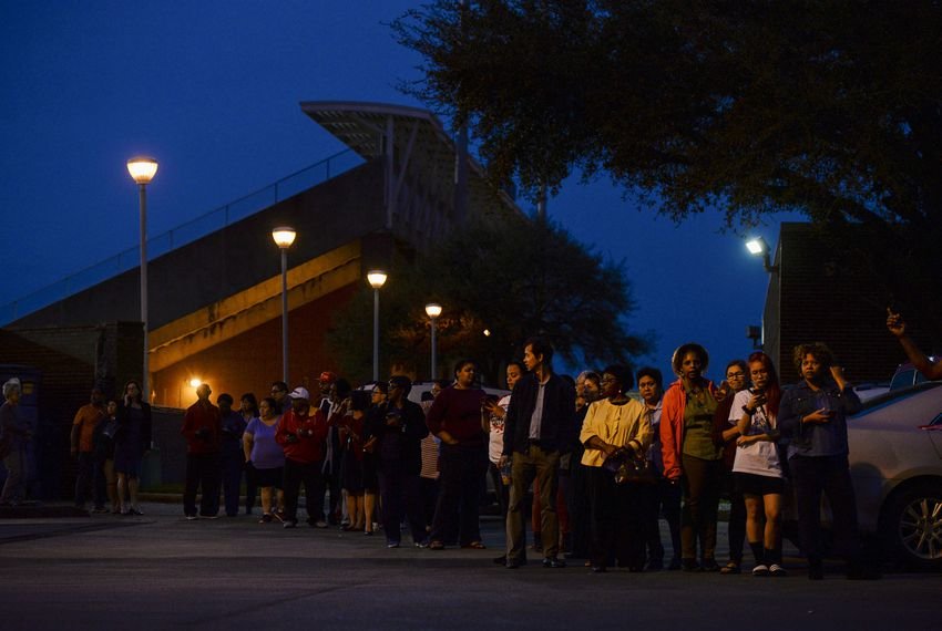 Voters wait in line to cast their ballot in the Democratic primary at a polling station in Houston on March 3, 2020.